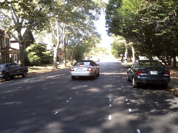 Paint guide markings for the new buffered bike lanes on Arsenal, west of Grand